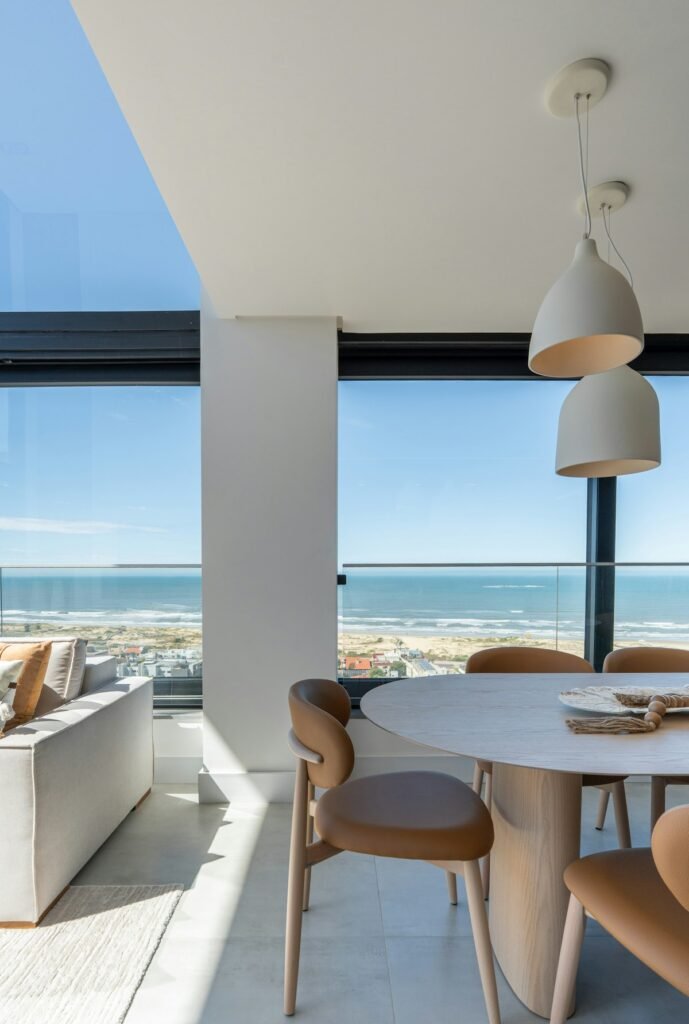Light, modern dining area with sea views through large windows